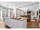 Open kitchen flowing into living area, features a kitchen island and fireplace at 129 Euharlee 5 Forks Rd, Euharlee, GA 30145