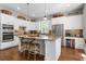 Bright kitchen featuring a large island with seating, granite countertops, and stainless steel appliances at 129 Euharlee 5 Forks Rd, Euharlee, GA 30145