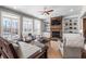 Inviting living room featuring a stone fireplace, built-in shelves, and ample seating at 129 Euharlee 5 Forks Rd, Euharlee, GA 30145