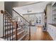Elegant living room featuring hardwood floors, a stone fireplace, and large windows for natural light at 129 Euharlee 5 Forks Rd, Euharlee, GA 30145