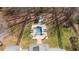 Aerial view of a beautiful in-ground pool with surrounding patio and lounge area in a fenced yard at 129 Euharlee 5 Forks Rd, Euharlee, GA 30145