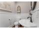 Powder room with pedestal sink, white wainscoting, and decorative mirror at 129 Euharlee 5 Forks Rd, Euharlee, GA 30145