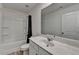 Bright bathroom featuring a tub with shower, modern vanity, and sleek fixtures at 2054 Hickman Walk, Suwanee, GA 30024