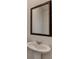Elegant bathroom featuring a pedestal sink and framed mirror for a classic touch at 2054 Hickman Walk, Suwanee, GA 30024