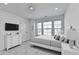 A bright bedroom features a modern design with clean lines, complemented by ample natural light at 2054 Hickman Walk, Suwanee, GA 30024