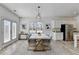 Modern dining area features an elegant light fixture and stainless steel appliances at 2054 Hickman Walk, Suwanee, GA 30024