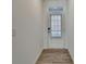 Bright entryway with wood-look floors and a door with window at 2054 Hickman Walk, Suwanee, GA 30024