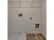 Bright laundry room with hookups, shelving, and a utility sink at 2054 Hickman Walk, Suwanee, GA 30024