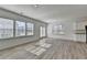 Spacious living room with wood floors, large windows, and a patio door at 2054 Hickman Walk, Suwanee, GA 30024