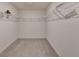 A walk-in closet with ample shelving that provides plenty of storage space at 2054 Hickman Walk, Suwanee, GA 30024