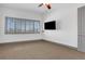 Cozy bedroom featuring carpet, a ceiling fan, and a large window for natural light at 4561 Olde Perimeter Way # 702, Atlanta, GA 30346