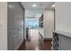 Hallway view leading to a kitchen and living area with wood floors and ample storage at 4561 Olde Perimeter Way # 702, Atlanta, GA 30346