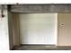 View of the unit's garage and roll-up style door at 4561 Olde Perimeter Way # 702, Atlanta, GA 30346