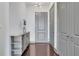 Neutral entryway featuring a decorative hall table, adjacent doors, and dark wood floors at 4561 Olde Perimeter Way # 702, Atlanta, GA 30346
