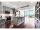 Modern kitchen with gray cabinets, stainless steel appliances, and a large island with granite countertops at 4561 Olde Perimeter Way # 702, Atlanta, GA 30346