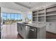 Kitchen island featuring granite countertops, a stainless steel dishwasher and shelving at 4561 Olde Perimeter Way # 702, Atlanta, GA 30346