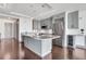 Well-appointed kitchen island with pendant lighting, wine rack, stainless steel appliances, and hardwood flooring at 4561 Olde Perimeter Way # 702, Atlanta, GA 30346