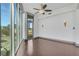 Bright living room featuring a ceiling fan and floor-to-ceiling windows offering city views at 4561 Olde Perimeter Way # 702, Atlanta, GA 30346