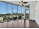 Bright living room featuring a ceiling fan and floor-to-ceiling windows offering city views at 4561 Olde Perimeter Way # 702, Atlanta, GA 30346