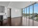 Bright living room featuring hardwood floors and floor-to-ceiling windows offering city views at 4561 Olde Perimeter Way # 702, Atlanta, GA 30346