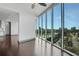 Bright living room featuring hardwood floors and floor-to-ceiling windows offering city views at 4561 Olde Perimeter Way # 702, Atlanta, GA 30346