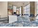 Bright, open lounge with an island, multiple seating options and floor-to-ceiling windows at 4561 Olde Perimeter Way # 702, Atlanta, GA 30346