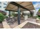 Outdoor bar area under a shaded structure with stools and seating area at 4561 Olde Perimeter Way # 702, Atlanta, GA 30346