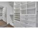 Spacious walk-in closet with custom white shelving and ample storage drawers at 4561 Olde Perimeter Way # 702, Atlanta, GA 30346