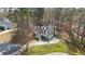 Aerial view of a charming home featuring a long driveway and a covered front porch at 55 Legend Creek Cove, Douglasville, GA 30134