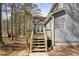 Exterior angle shows a deck with stairs off the back of the house at 55 Legend Creek Cove, Douglasville, GA 30134