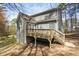 Exterior shot shows a deck with stairs off the back of the house at 55 Legend Creek Cove, Douglasville, GA 30134