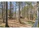 The backyard has a deck and is surrounded by mature trees offering privacy and a natural setting at 55 Legend Creek Cove, Douglasville, GA 30134