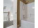 Standard shower and bathtub combo with door leading to carpeted stairway at 55 Legend Creek Cove, Douglasville, GA 30134