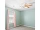 A naturally illuminated bedroom with a modern ceiling fan and neutral gray carpet flooring at 55 Legend Creek Cove, Douglasville, GA 30134