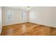 This bedroom features wood flooring, base molding, and two large windows at 55 Legend Creek Cove, Douglasville, GA 30134