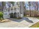 View shows a long driveway that curves up to the front of the house at 55 Legend Creek Cove, Douglasville, GA 30134