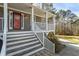 Inviting front porch with white railings leading to the home's entrance with stairs at 55 Legend Creek Cove, Douglasville, GA 30134