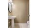 The half bathroom features a pedestal sink, framed mirror, and tile flooring at 55 Legend Creek Cove, Douglasville, GA 30134