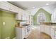 Well-lit kitchen with white cabinets, granite countertops, and a range at 55 Legend Creek Cove, Douglasville, GA 30134