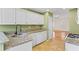 Spacious kitchen featuring white cabinets, granite countertops, and stainless steel sink at 55 Legend Creek Cove, Douglasville, GA 30134