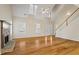 Open-concept living area with hardwood floors, a fireplace, and a staircase at 55 Legend Creek Cove, Douglasville, GA 30134