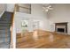 Spacious living room with hardwood floors, a fireplace, and access to the staircase at 55 Legend Creek Cove, Douglasville, GA 30134