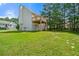 Backyard with a large grassy area, a deck, and wooded area at 125 Fairhaven Trl, Fairburn, GA 30213