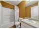 Bathroom with shower-tub, vanity sink, and golden walls at 125 Fairhaven Trl, Fairburn, GA 30213