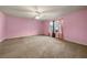 Spacious bedroom with wall to wall carpet, ceiling fan, and two large windows at 125 Fairhaven Trl, Fairburn, GA 30213