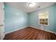 Cozy bedroom with hardwood floors and a view of the outside at 125 Fairhaven Trl, Fairburn, GA 30213