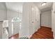 Bright entryway features hardwood floors, coat closet, and large window above the front door at 125 Fairhaven Trl, Fairburn, GA 30213