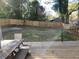 Large backyard with wooden fence and mature trees provides privacy and space for outdoor activities at 245 Mathewson Pl, Atlanta, GA 30314