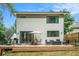 Modern home featuring a spacious deck with ample seating and a serene backyard with a wooden fence at 245 Mathewson Pl, Atlanta, GA 30314