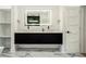 Sleek bathroom with double vanity, modern lighting, and black and white accents at 245 Mathewson Pl, Atlanta, GA 30314